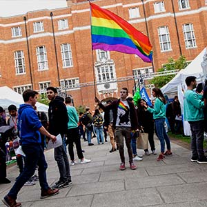 A student holding a pride flag