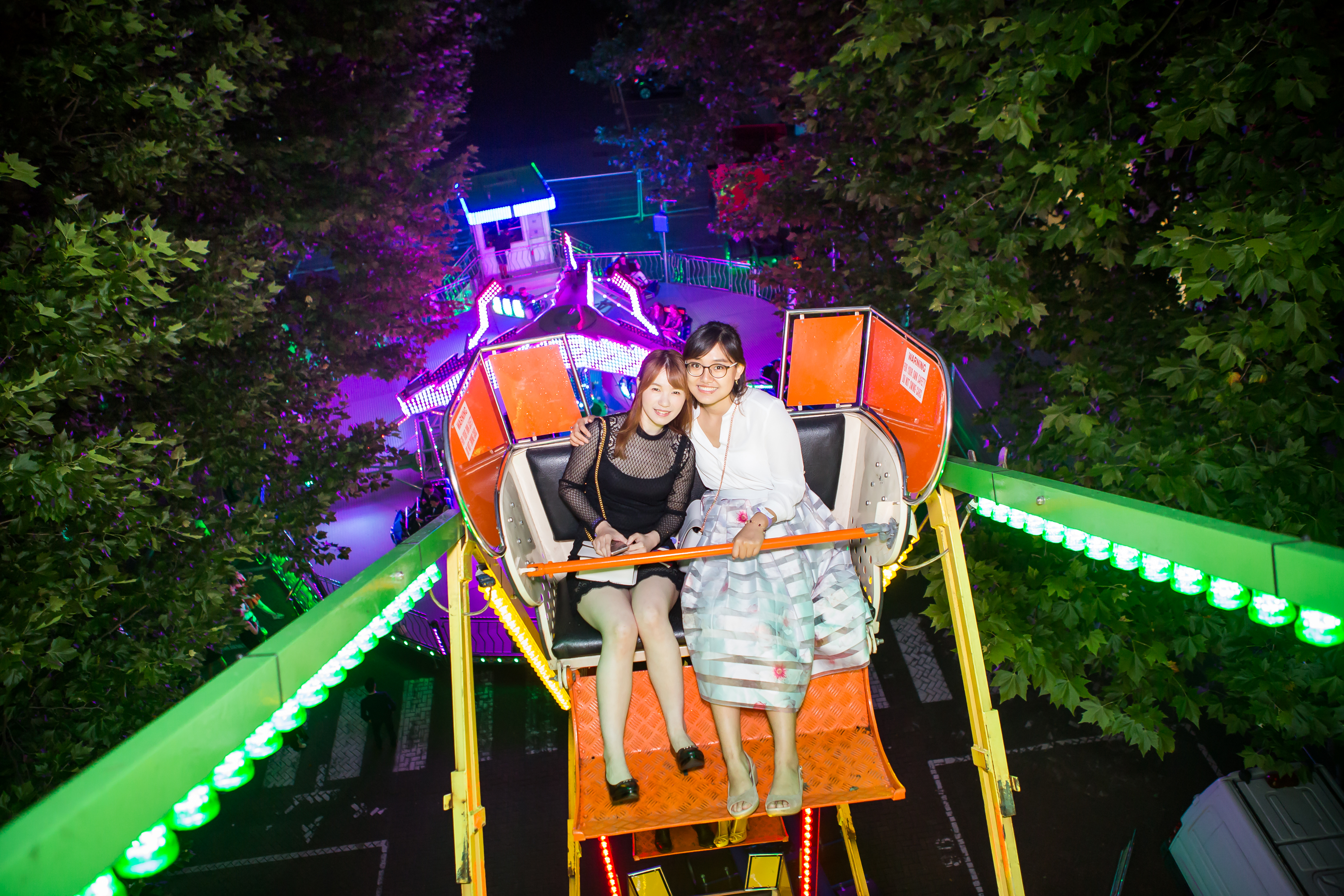 Two students on the big wheel viewed from the next seat above.